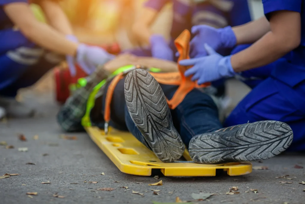 Injured construction worker on stretcher during extreme heat.